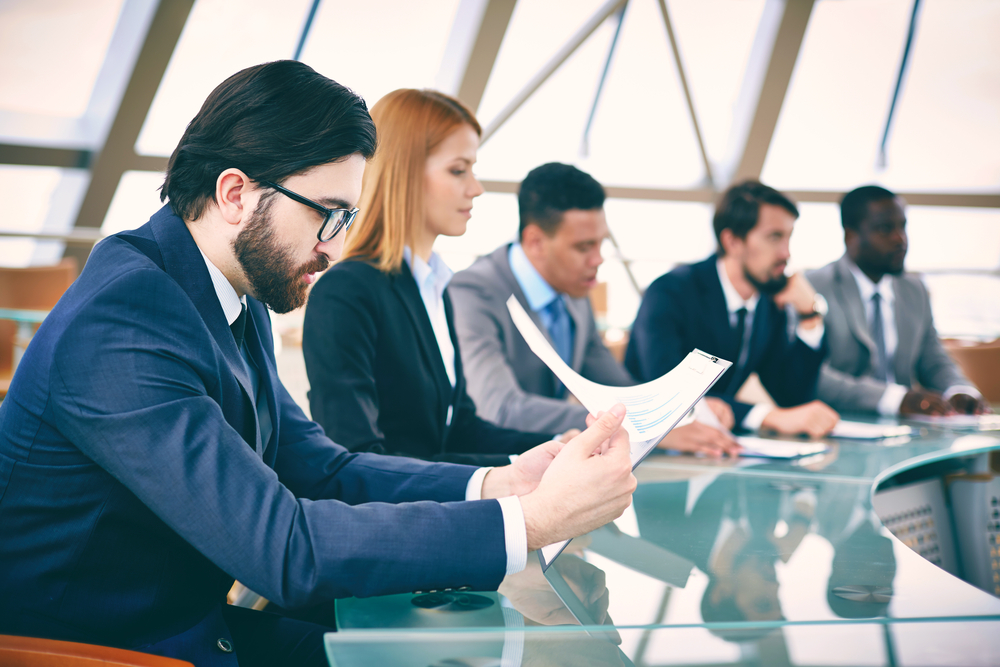 Row,Of,Business,People,Listening,To,Presentation,At,Seminar,With