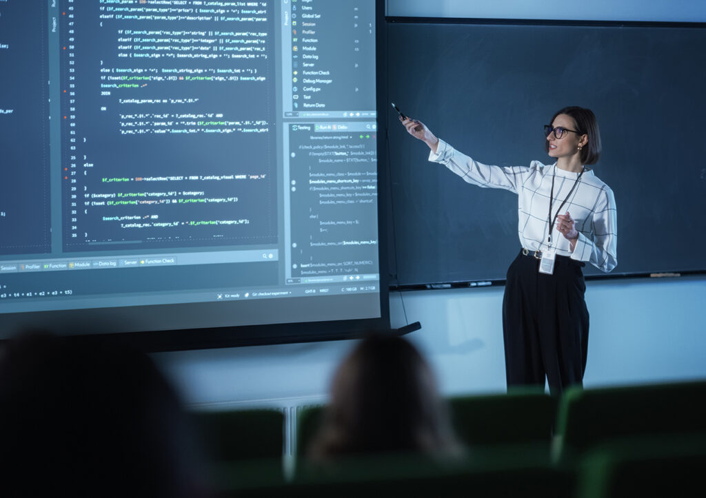 Cybersecurity and Intelligence class taught by female teacher pointing to screen